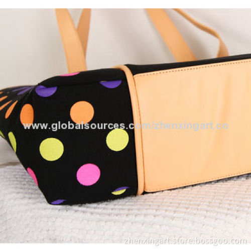 Black canvas handbag with colorful dots